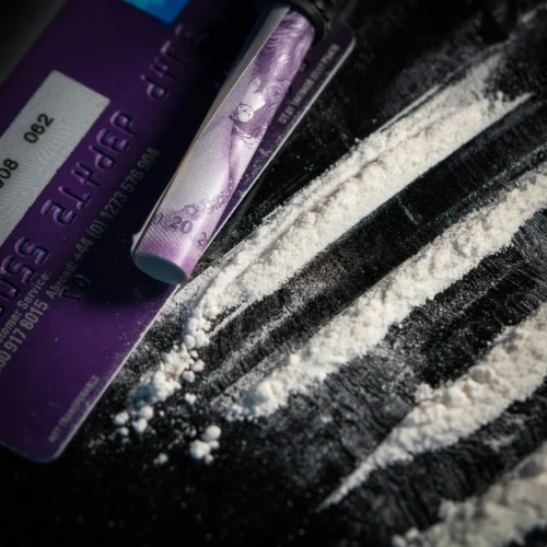 White Freebased Cocaine Powder on a Table with Rolled up Money