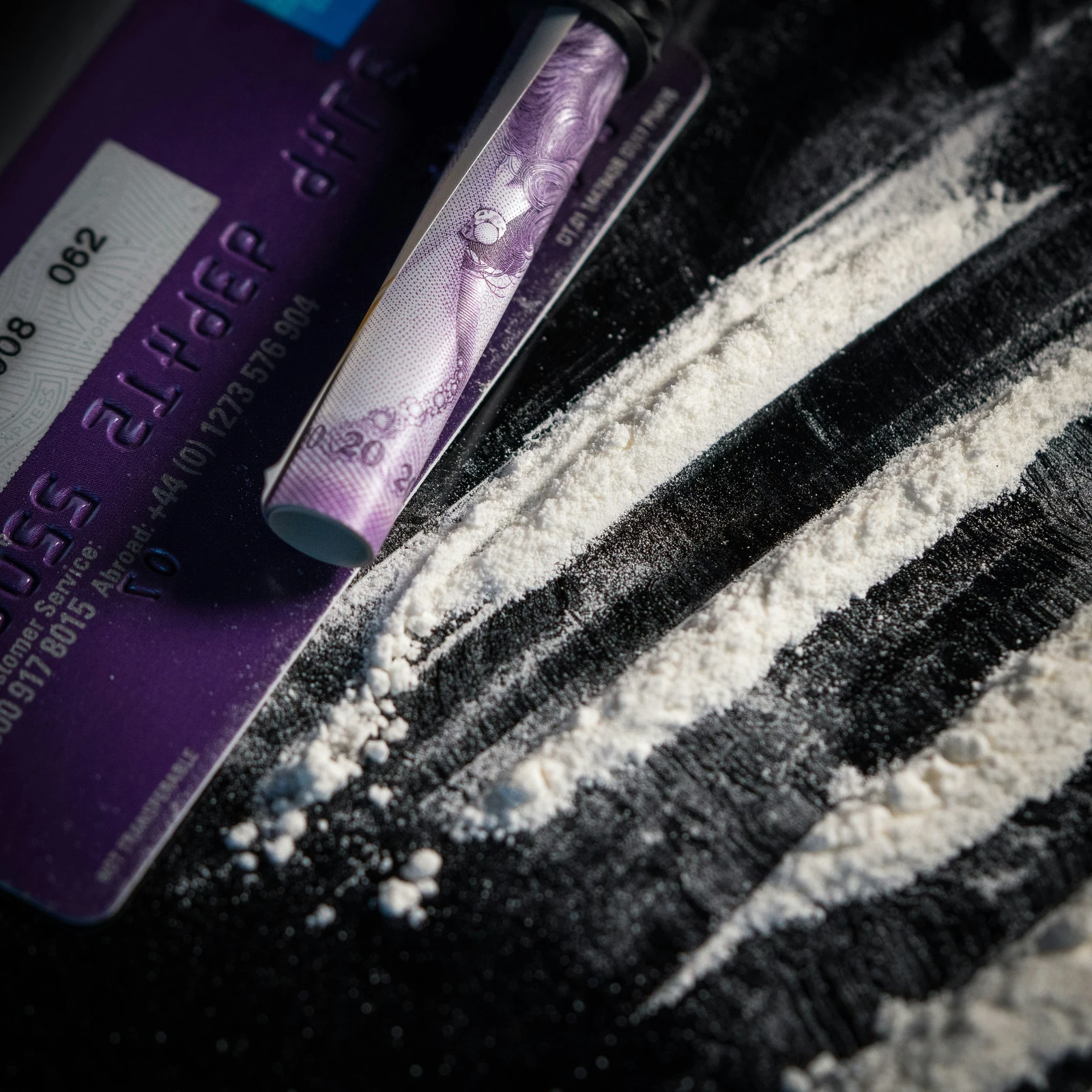 White Freebased Cocaine Powder on a Table with Rolled up Money