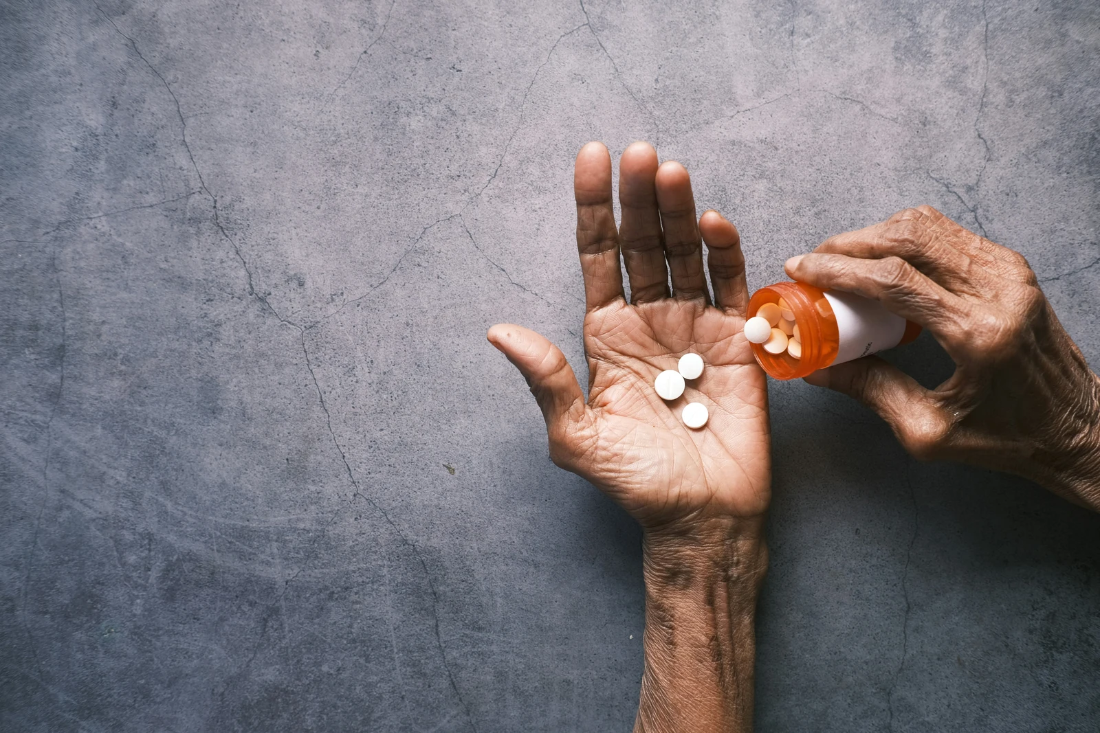 Hand outstretched with lorazepam pills being poured from a bottle