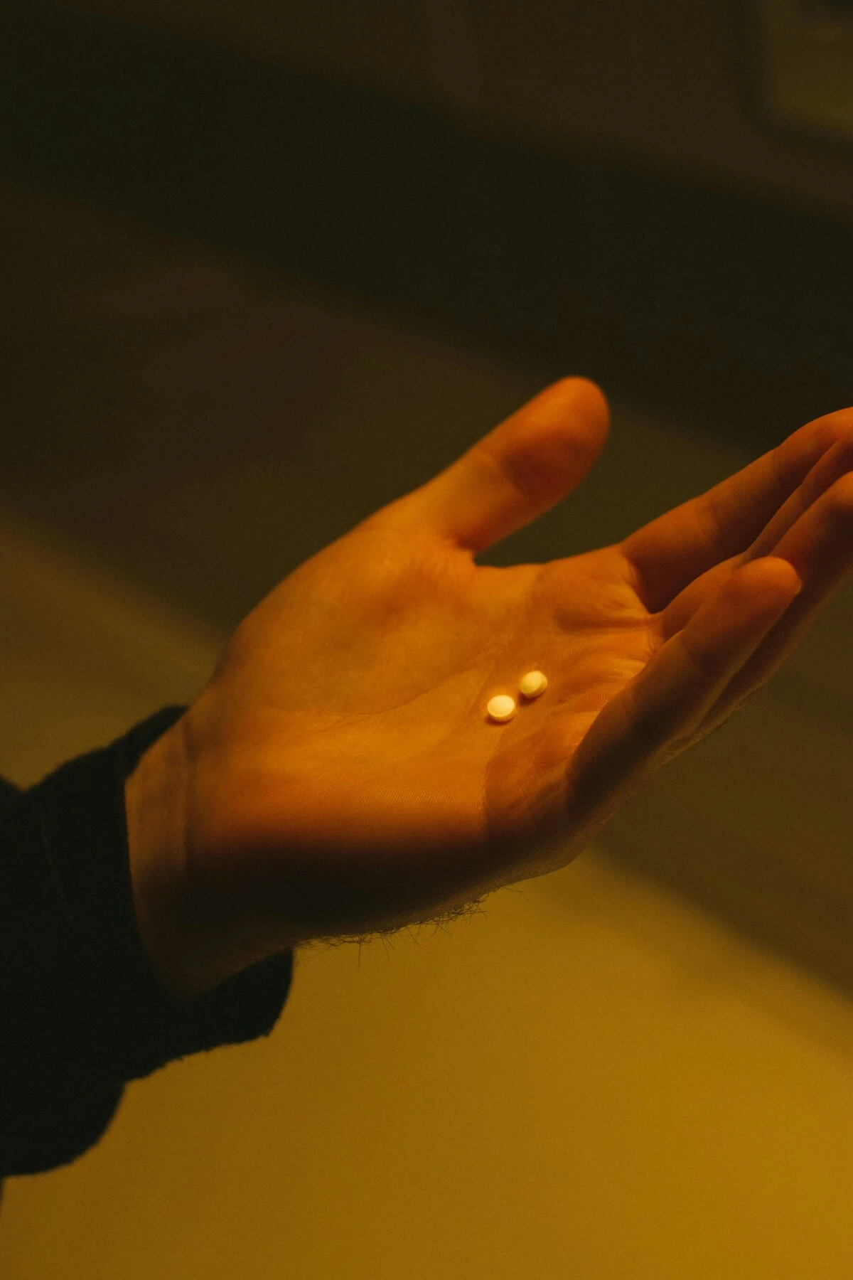 Hand holding ambien pills