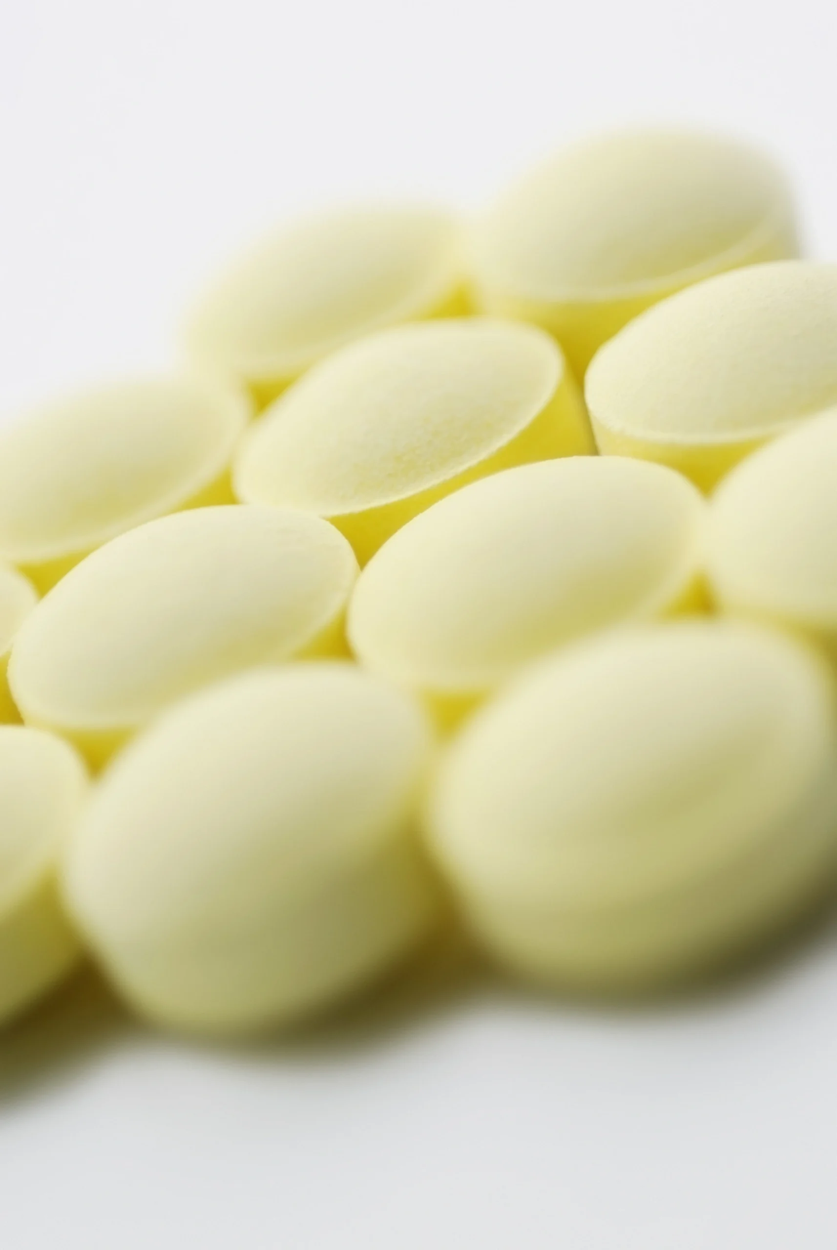 Meloxicam pills arranged together neatly on a white background